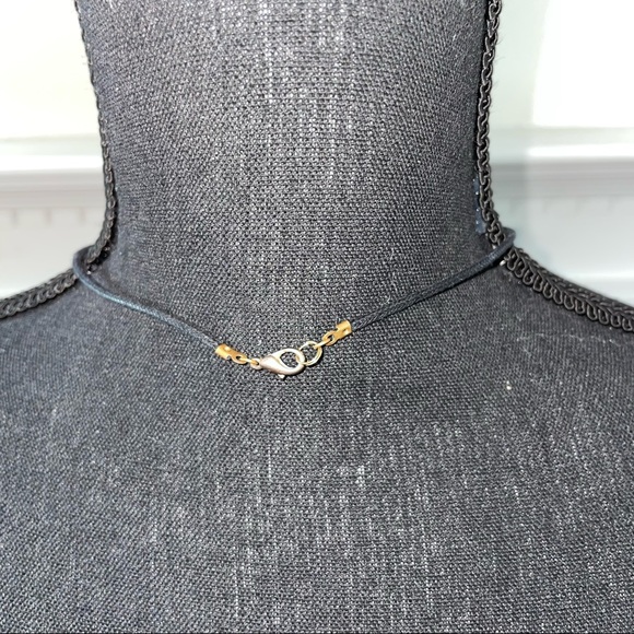 Black cord necklace with unique coral colored shell. - Picture 2 of 3